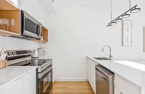 Mount Pleasant Apartment | Elegant Calgary Abode: Fitness Studio, Sauna, Billiards.