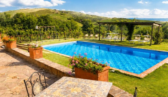 An old Tuscan stone farmhouse with a pool and vineyard in the Val d'Orcia